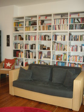 Wohnzimmer mit Bücherwand und Sternkissen
